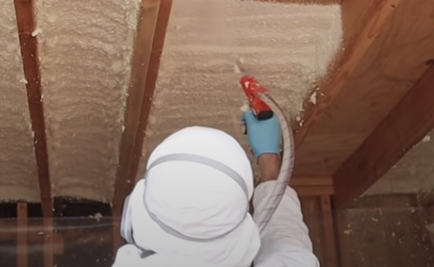 spraying foam with insulation gun