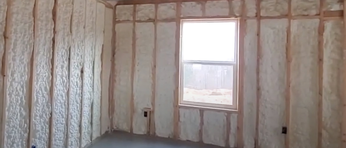Office wall with new spray foam insulation installation